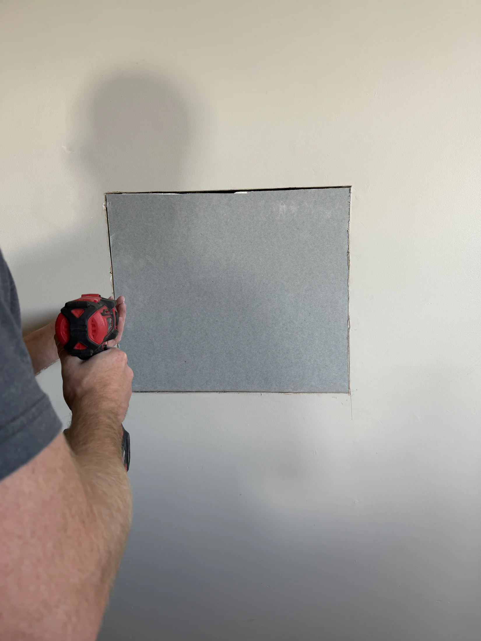 New gib patch being screwed into the wall