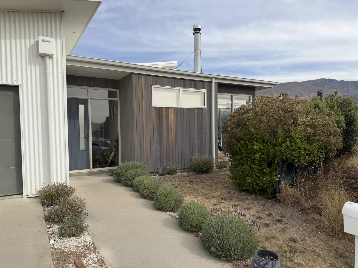 Cedar cladding that has faded and lost its colour but is still sound