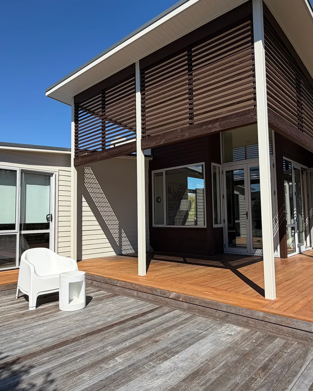 Painted exterior and cedar screens overlooking a Wānaka deck