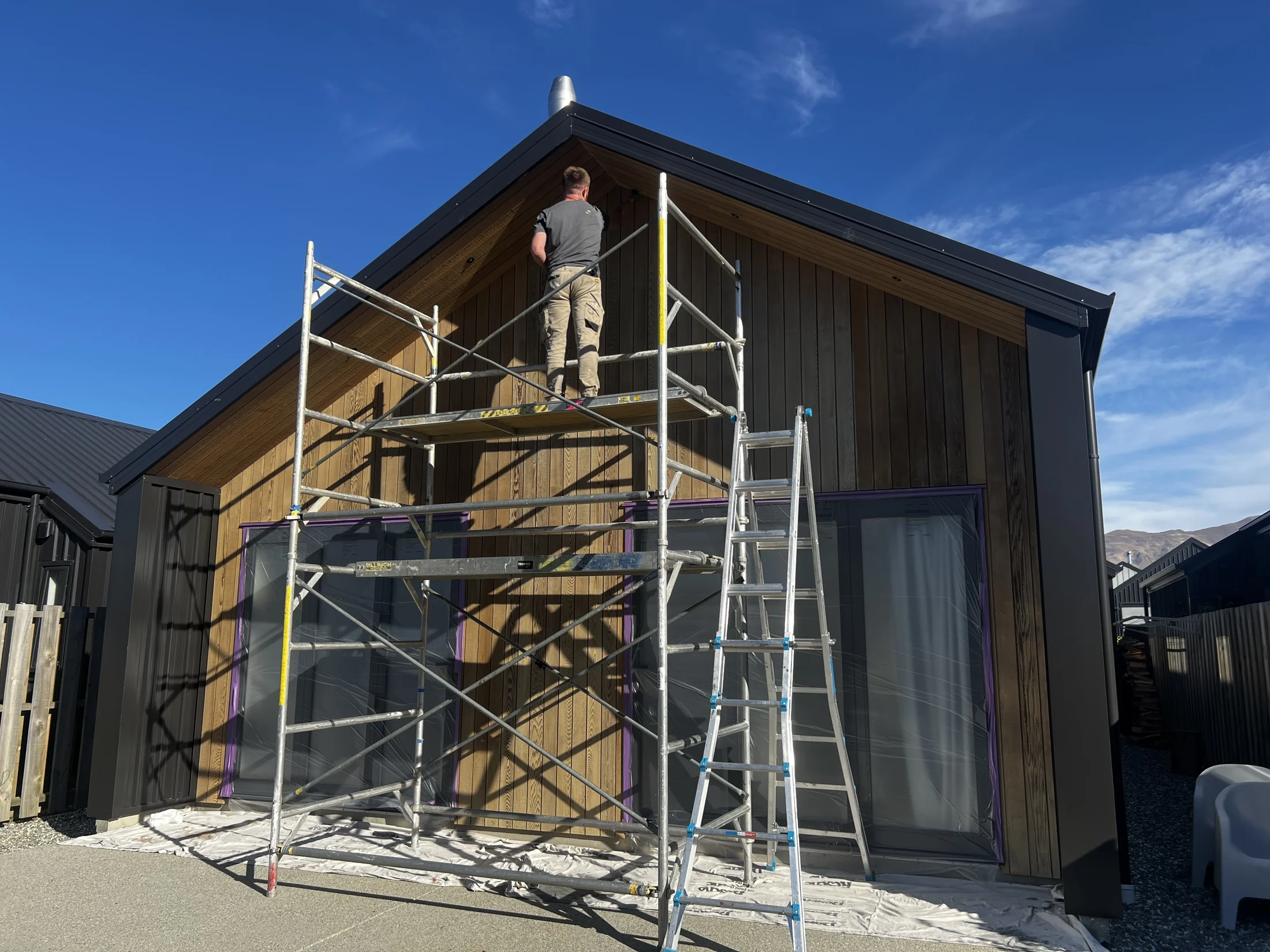 Cedar Oil Refresh in Northlake, Wānaka - Process 1: Applying Cedar Oil Stain From Scaffold Northlake Wanaka