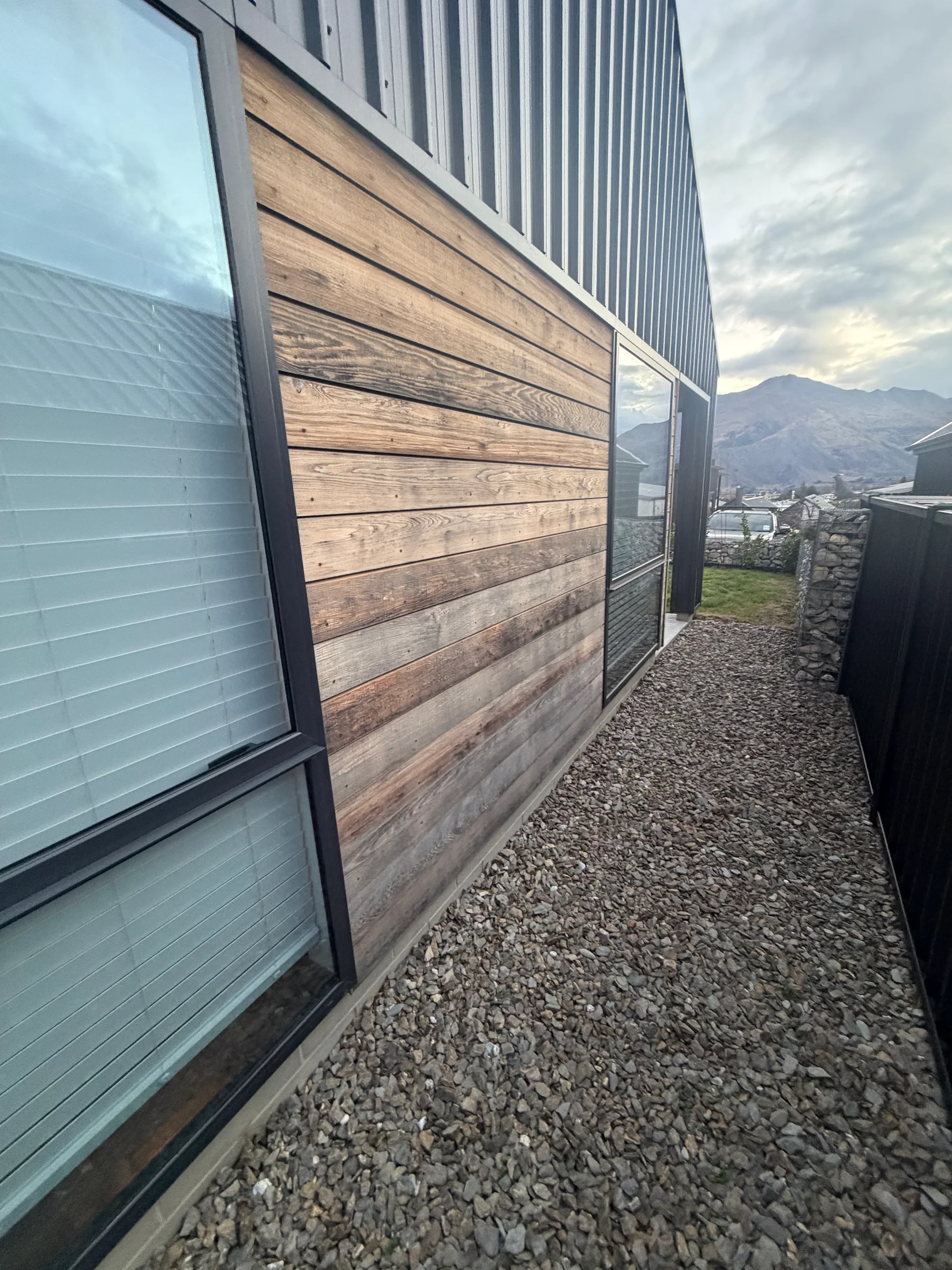 Faded cedar side cladding before cleaning in Wānaka
