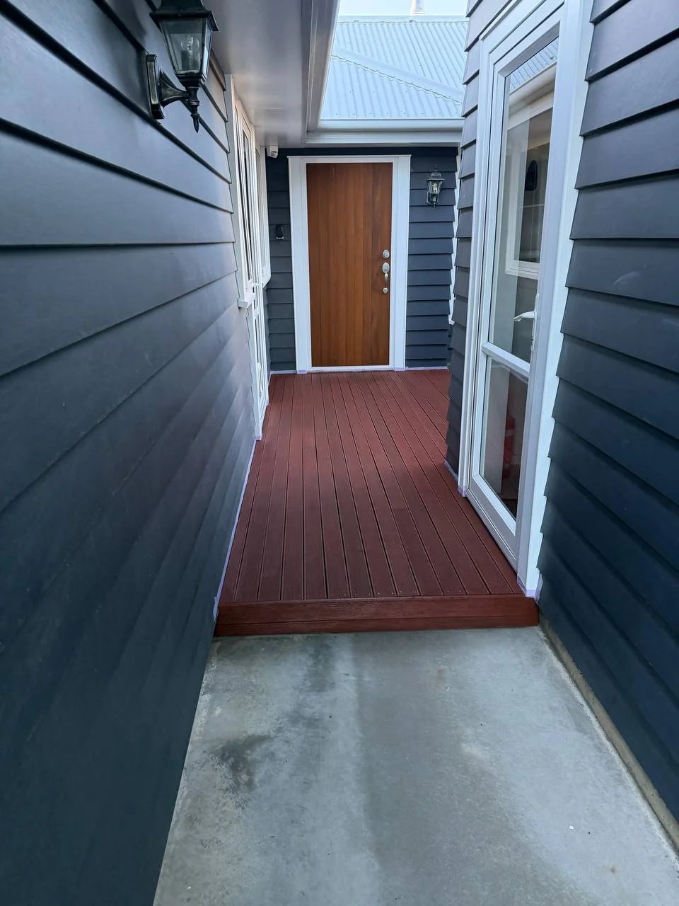 Exterior Repaint & Deck Stain, Albert Town - After 1: Entry Corridor Restained Deck Timber Door White Frames Albert Town