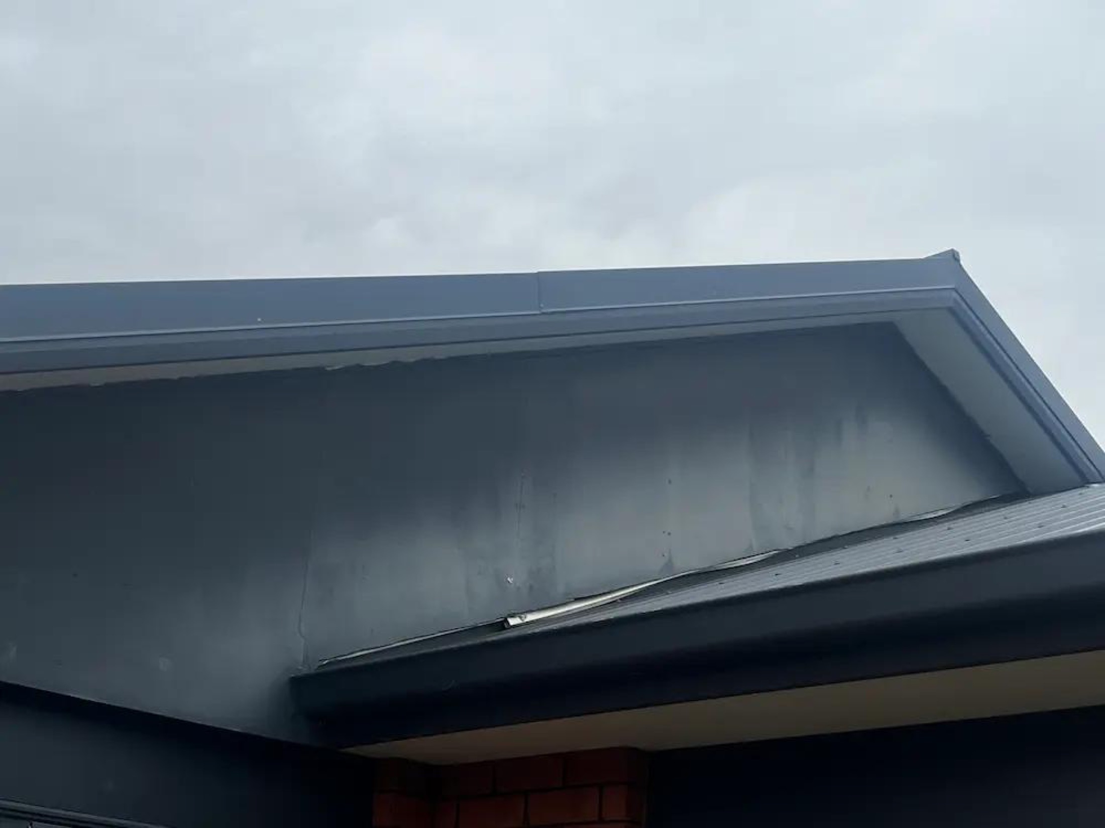 Repaint of Gables in Wanaka - Before 1: Chalking Gable Eave Closeup Before Painting Wanaka