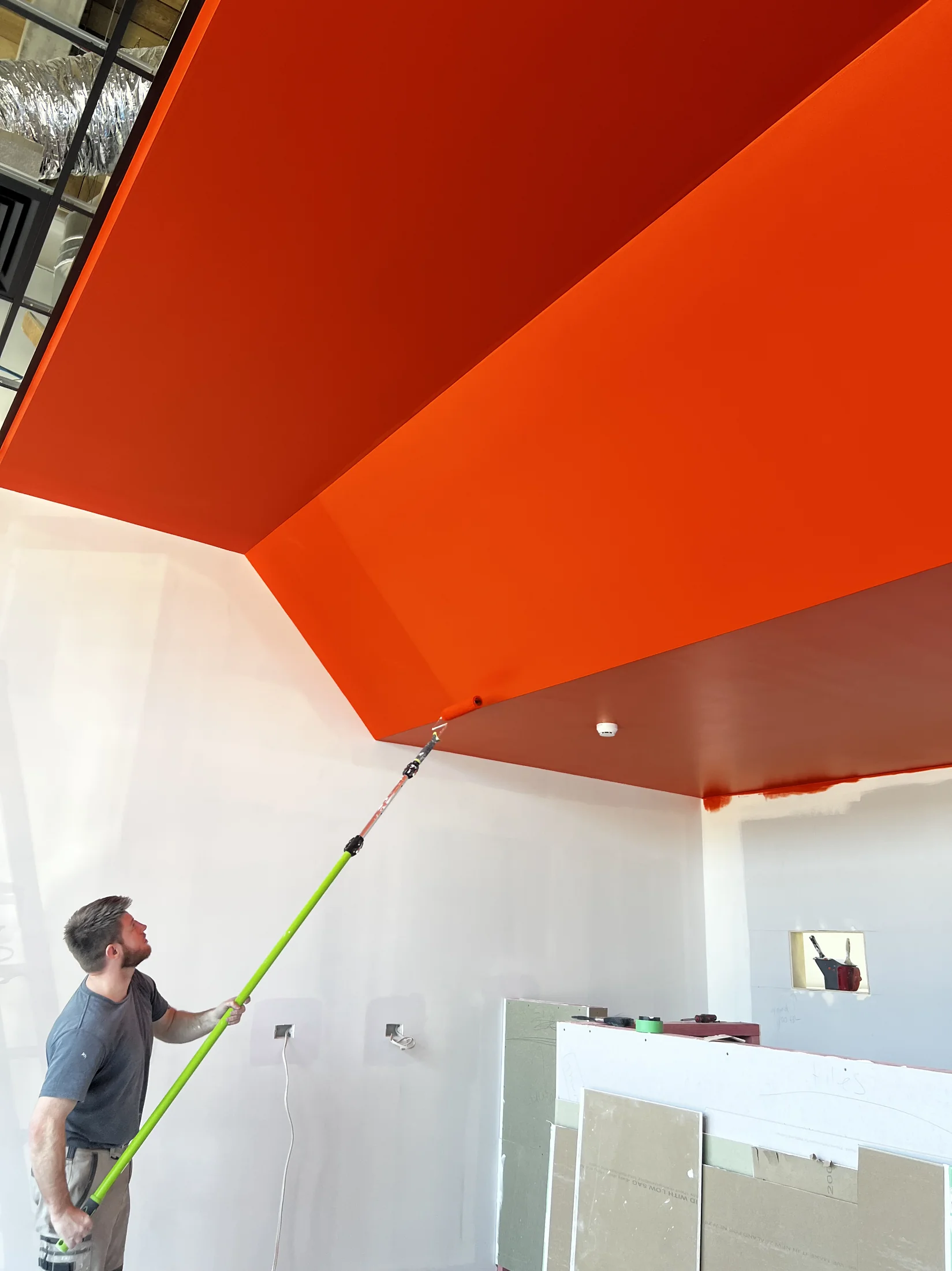 Tank Store Fitout, Three Parks Wanaka - Process 4: Orange Feature Ceiling Painting In Progress Tank Three Parks Wanaka