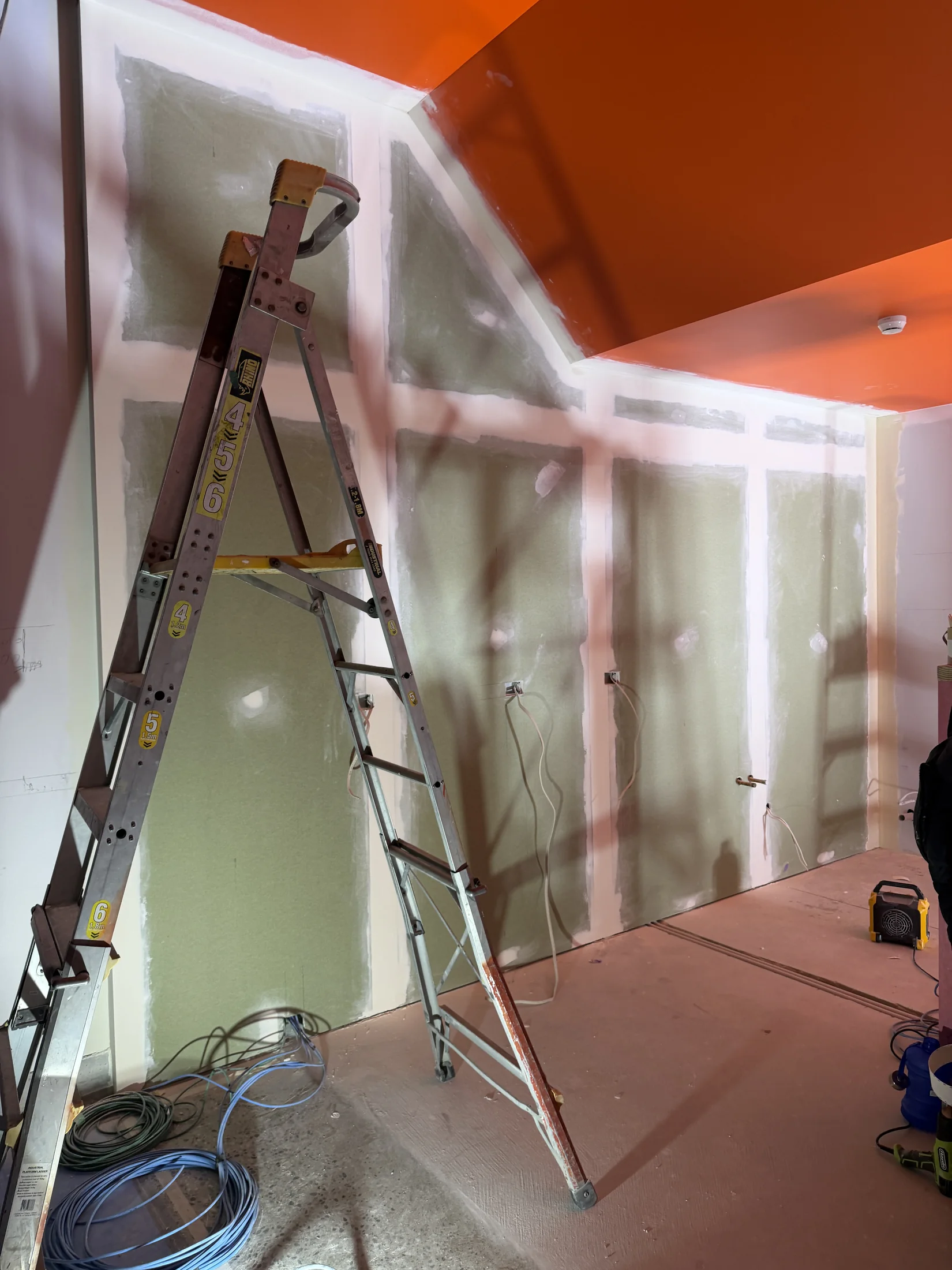 Tank Store Fitout, Three Parks Wanaka - Process 7: Prepared Walls Beneath Orange Ceiling Tank Three Parks Wanaka
